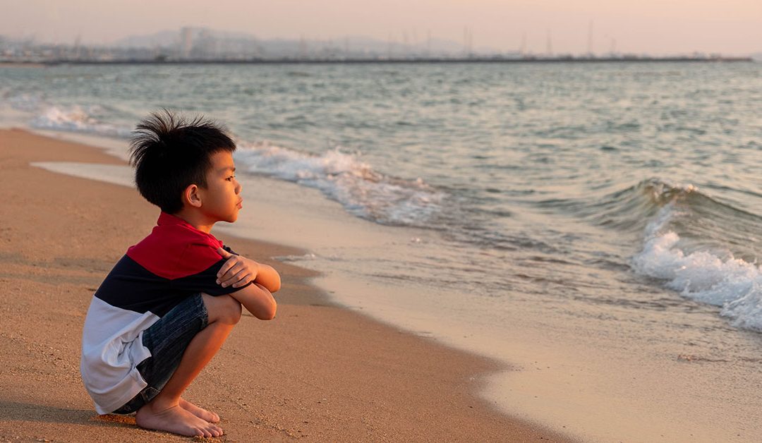 Boy looking out to the ocean